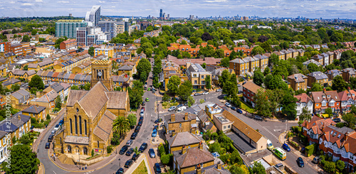 Photography Ealing church in London with green suburb and distant city skyline view