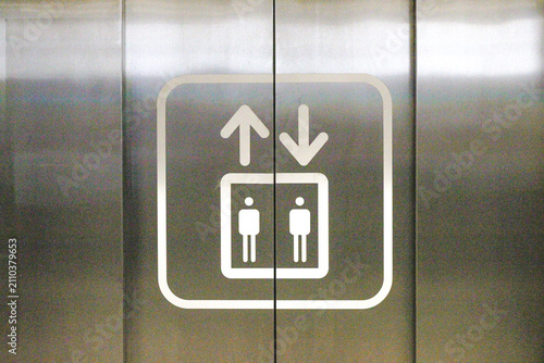 Elevator symbol on stainless steel lift doors