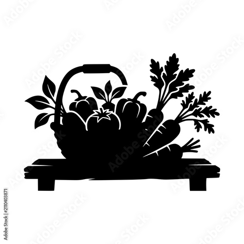 Silhouette of a basket filled with fresh garden vegetables on a wooden table