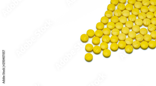 Картината върху платно Yellow small round tablets pills on white background