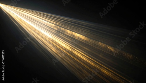 Dramatic diagonal beam of light flares outwards against a deep black background, creating an ethereal glow