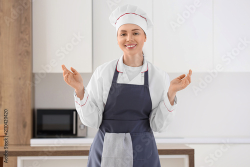 Smiling female chef in a wh...