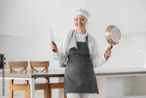 Smiling female chef in unif...