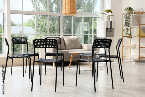 Empty black chairs arranged...