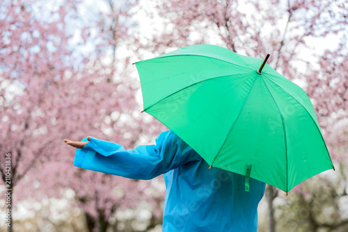 Woman with raincoat and gre...