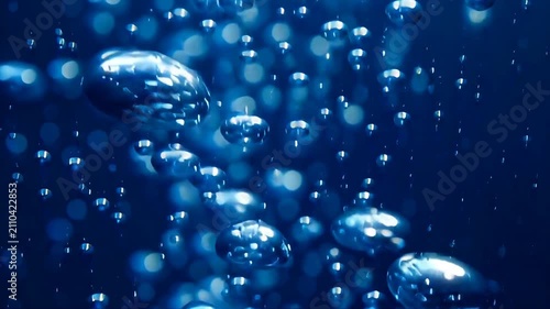 Blue Water Bubbles Rising in Liquid with Light Reflections