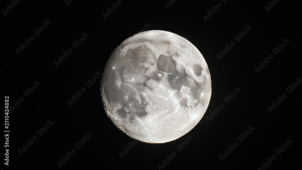 Obraz premium Full moon glowing brightly in the dark night sky showing detailed craters and lunar surface texture against a pitch black celestial background with natural cosmic light