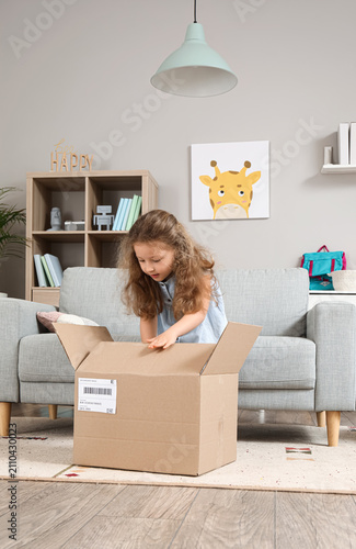 Cute little girl unpacking ...