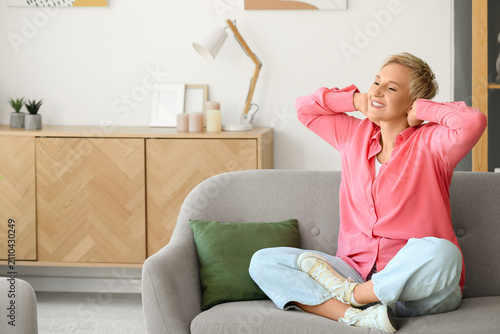 Happy mature woman sitting ...