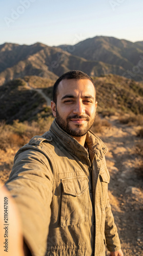 Middle Eastern Male Journalist Recording Self-Shot Video Dispatch in Mountainous Landscape at Golden Hour