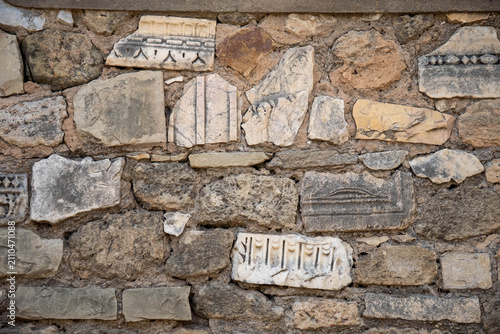Fotografie Carved stones embedded in a wall in the ancient ruins of Carthage, on the outski