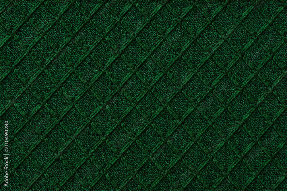 Obraz premium Deep emerald green quilted textured background with subtle weave detail and diamond pattern