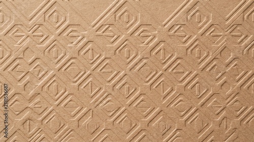 Embossed brown paper texture with geometric pattern, recycled cardboard background with raised relief design, tactile craft paper surface