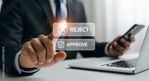A professional businessman in a suit making a decision by pressing a digital reject button on a virtual interface while holding a smartphone at his desk