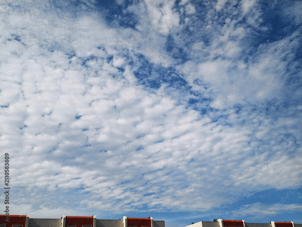 Fototapeta premium Dramatic Clouds Above Residential Rooftops 