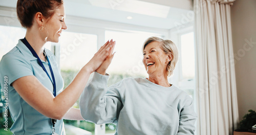 Cuadro en lienzo Physiotherapist, woman and laugh in office with high five, recovery goals and complete injury treatment
