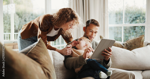 Obraz na plátně Smile, parents and toddler at house with tablet, social media and watching cartoon for bonding