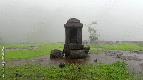 Historic remnants of the Maratha Empire on Siddhagad Fort, Maharashtra, amidst the Sahyadri mountains.