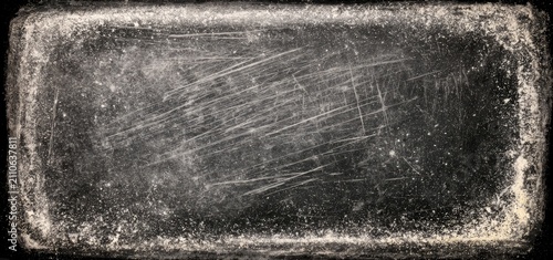Close-up of a scratched and weathered metallic surface with a distressed texture.