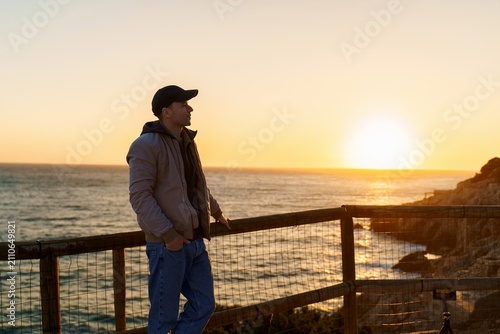 Side portrait of man looking over sunset sea