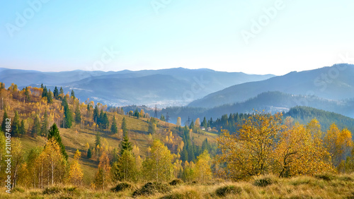Konstfotografi Autumn colored valley and mountains in haze