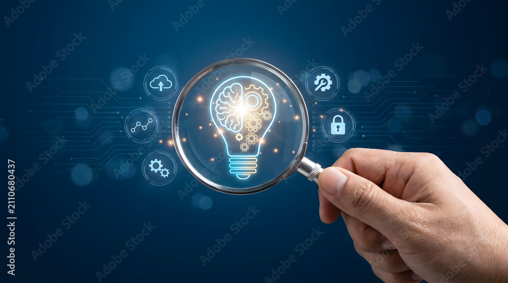 Fototapeta premium Hand holding magnifying glass focusing on glowing brain and gear lightbulb, artificial intelligence, Digital innovation and machine learning research concept.
