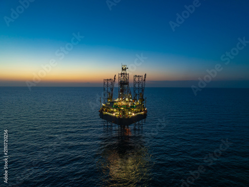 Aerial view of offshore jack up rig and offshore platform during sunset
