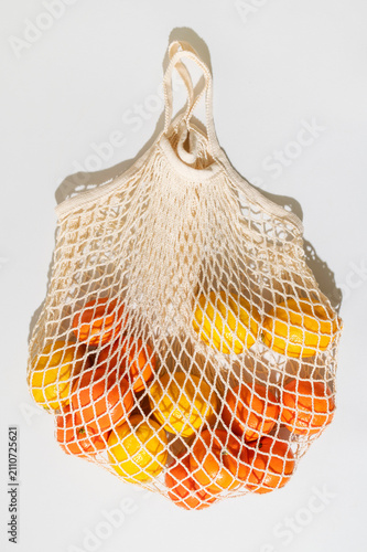 Fresh lemons and mandarins inside mesh bag present vitamin rich nutrition concept, citrus inspired healthy eating, natural produce selection, vitamin focused branding, educational wellness content.