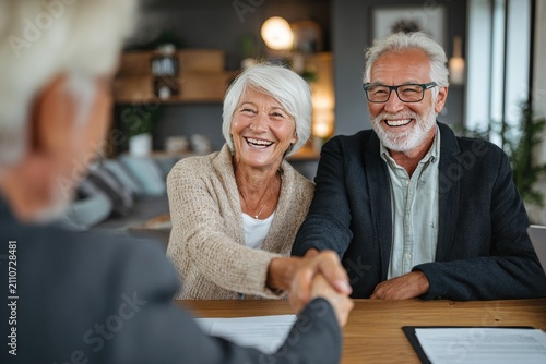 Elderly Couple Shaking Hands with Real Estate Agent Sealing Deal