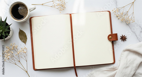 Minimalist open notebook mockup on white marble, blank leather journal with coffee and dried flowers, aesthetic workspace flat lay for blogging