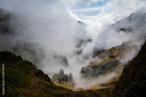 Fotografija Clouds billowing up from a green ravine in a stunning cloud inversion, Madeira m