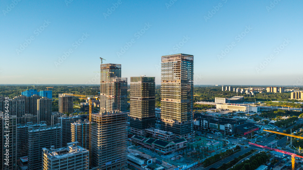 Obraz premium Urban new district with towering skyscrapers under construction and bustling site landscape