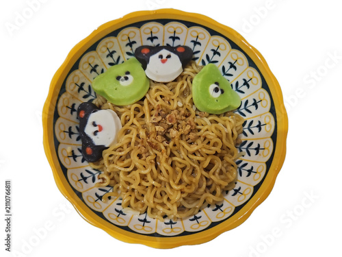 Konstfotografi Top down view of a bowl of Asian fried instant noodles sprinkled with fried shallots and garnished with cute cartoon character shaped fish cakes