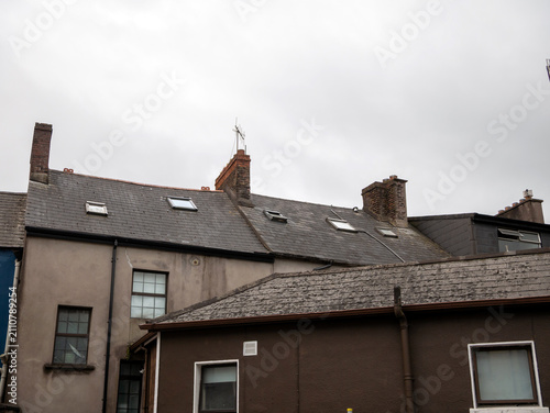 Old residential rooftops under a cloudy sky