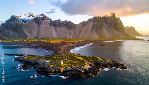 Aerial view of a stunning coastal landscape, featuring mountains, ocean, a small island with a lighthouse, and dramatic lighting