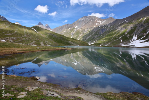 Goleon lake, reached by a hiking trail and located above the village La Grave, Romanche Valley, Hautes Alpes (French Southern Alps), France, with reflections of mountains (Aiguilles d'Arves)