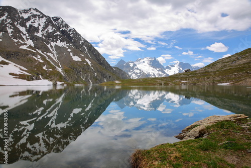Goleon lake, reached by a hiking trail and located above the village La Grave, Romanche Valley, Hautes Alpes (French Southern Alps), France, with reflections of mountains (La Meije mountain range)