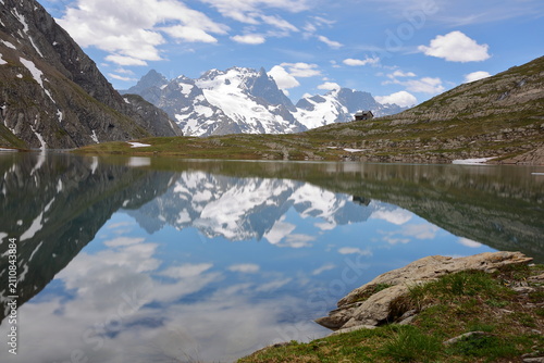 Goleon lake, reached by a hiking trail and located above the village La Grave, Romanche Valley, Hautes Alpes (French Southern Alps), France, with reflections of mountains (La Meije mountain range)