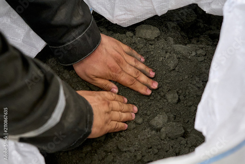 Construction Worker Inspecting Concrete Mix