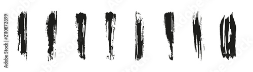 Fotografía Vertical black ink brush strokes with varied textures and thickness on white bac