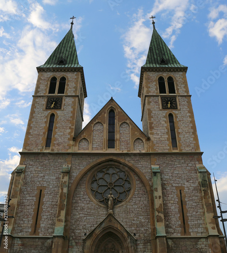 Bild auf Leinwand Sacred Heart Cathedral aka Sarajevo  Cathedral with clocks and Blue Sky Backgrou