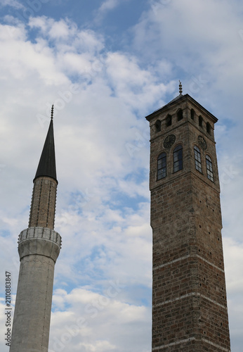 Minaret of Gazi Husrev Beg Mosque and Clock Tower with Blue Sky Background in Sarajevo, Bosnia and Herzegovina