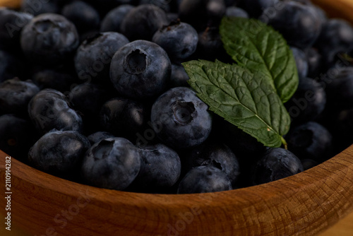 Close-Up of Fresh Blueberries with Mint in Wooden Bowl