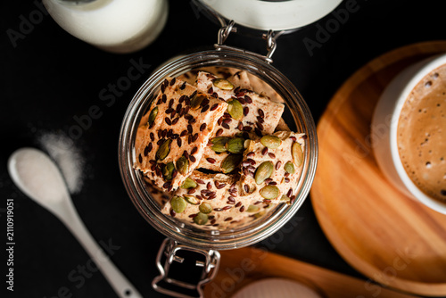 Quadro su tela Cereal cookies in a transparent jar on a dark background