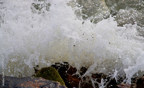 Close up shot of splashing sea surf crashed against the rocks