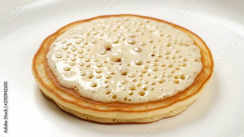 Thick, Fluffy Pancake With Bubbles Cooking On Griddle, Ideal For Breakfast And Brunch Menus Displaying Comfort Food Appeal