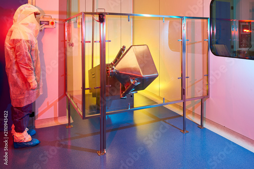 Фотография Science worker observing industrial pharmaceutical blender mixing
