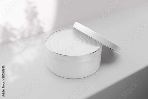 Foto Cosmetic tin jar mockup with open lid leaning on container, blank white round me