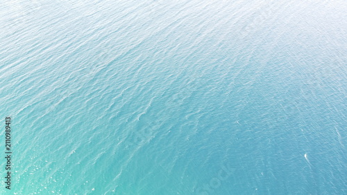 Deep Blue Sea Waters with Island Horizon and Clouds, Aerial View