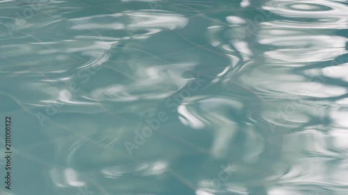 Slow motion shot of clean swimming pool ripples and wave.
